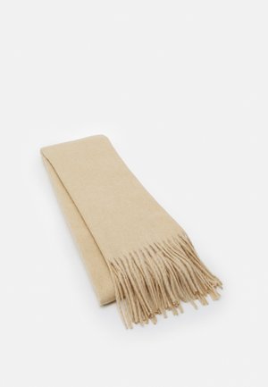 Beige wollen sjaal met franjes aan de uiteinden, platgevouwen liggend op een witte achtergrond.