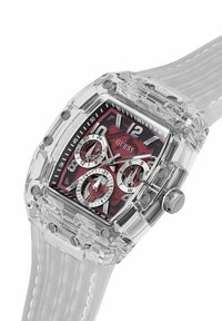 Clear watch with a rectangular case, red patterned dial, silver sub-dials, and a transparent silicone strap. Accents include bold hour markers.
