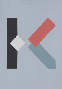 Light blue fabric featuring a geometric design: black rectangle, white diamond, and red and blue shapes. Flat texture with bold colors.