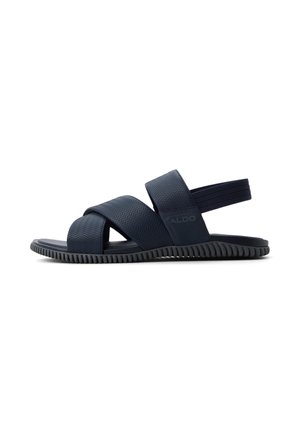 Sandale bleu marine pour homme avec des brides croisées texturées, bande élastique au talon et semelle flexible rainurée.