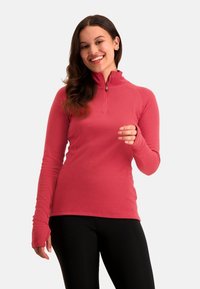 Koraal kleurige hoodie met ritssluiting en lange mouwen. Bevat raglanmouwen en duimopeningen. Draagt samen met zwarte leggings, gladde textuur en aansluitend ontwerp.