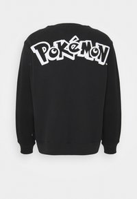 Felpa nera con un grande logo bianco "Pokémon" sul retro, realizzata in un materiale morbido con polsini e orlo a coste.