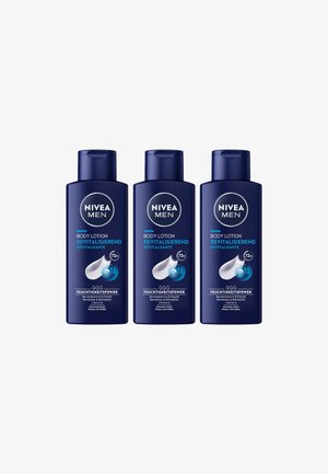 Three navy blue NIVEA Men body lotion bottles labeled "Revitalizing" with 72-hour hydration and Vitamin E for normal skin.
