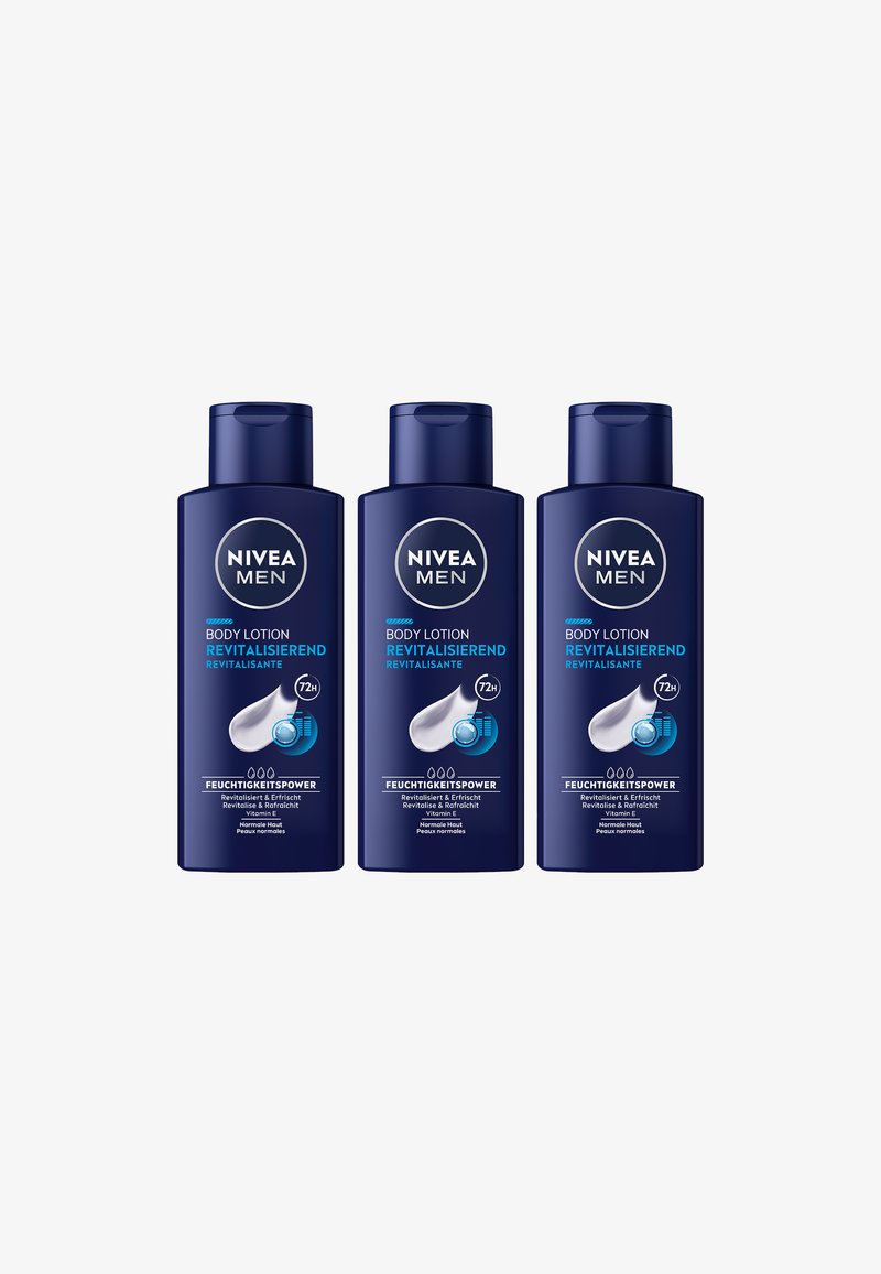 Three navy blue NIVEA Men body lotion bottles labeled "Revitalizing" with 72-hour hydration and Vitamin E for normal skin.