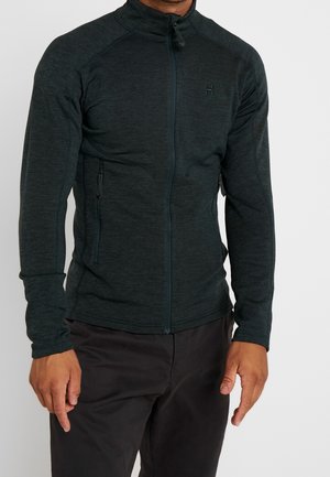 Veste zippée gris foncé en tissu texturé avec des manches longues, un col haut et une poche zippée sur le côté. Logo sur la poitrine.