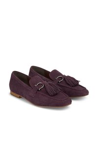 Purple suede loafers with tassel and silver hardware accents. Rounded toe and flat sole design. Smooth texture with detailed stitching.