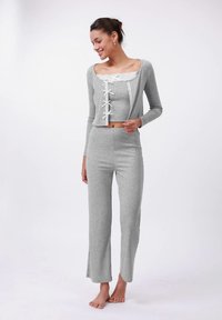 Gray crop top and matching pants made of soft fabric. Top features lace trim and ribbon accents, while pants have slight flares at the hems.