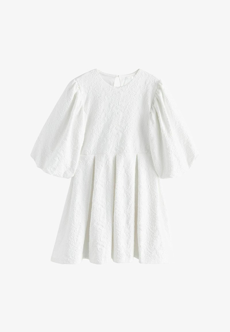White textured dress with puffed long sleeves, round neckline, pleated skirt, and a small keyhole button closure at the back.