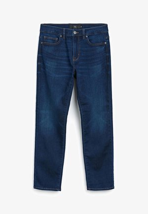 Tumed sinine teksariie sirge säärega, viis taskut ja kontrastset oranži õmblust. Sile tekstuur, kergelt pleekinud piirkondades reitel.