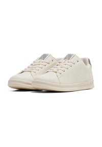 White leather sneakers with a smooth texture, lace-up design, perforated accents on sides, and a light rubber sole. Silver detail on heel.