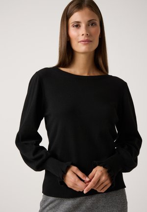 Zwarte gebreide trui met lange mouwen, voorzien van rimpelmanchetten en een ronde halslijn. Zachte textuur en een slim fit ontwerp.