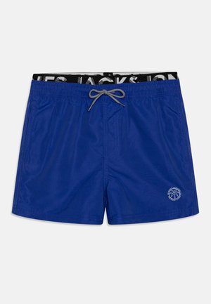 Pantaloni da bagno blu realizzati in materiale leggero, con una vita elastica adornata da una fascia con logo in bianco e nero e un piccolo emblema di palma.