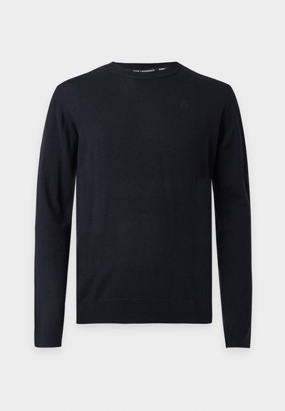 Pull noir à manches longues avec col rond, poignets et ourlet côtelés, présenté sur un fond gris clair uni.