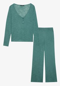 Teal long-sleeve top with a V-neck and two button accents, paired with matching wide-leg pants, both featuring a textured, slub fabric.