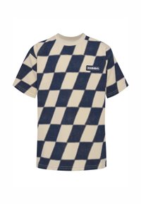 Kortärmad t-shirt i krämfärg med stort marinblått rutmönster. Har en fyrkantig Hummel-logotyp på vänster bröst. Mjukt, lätt material.