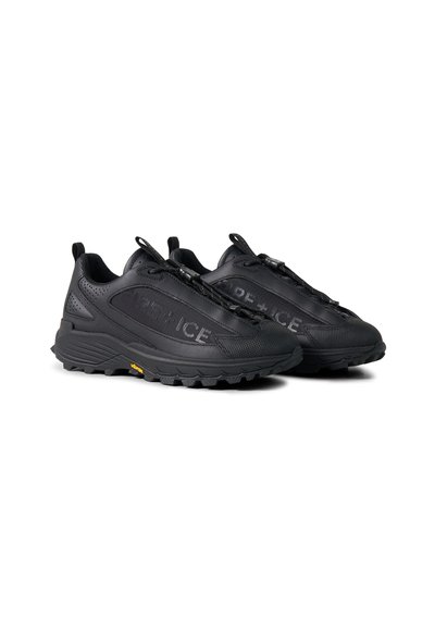 Pair of black low-top sneakers with textured soles, pull tabs, and elastic laces, featuring embossed text on outer sides.