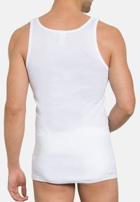 White cotton tank top with a round neckline and wide shoulder straps, featuring a fitted design and smooth texture.