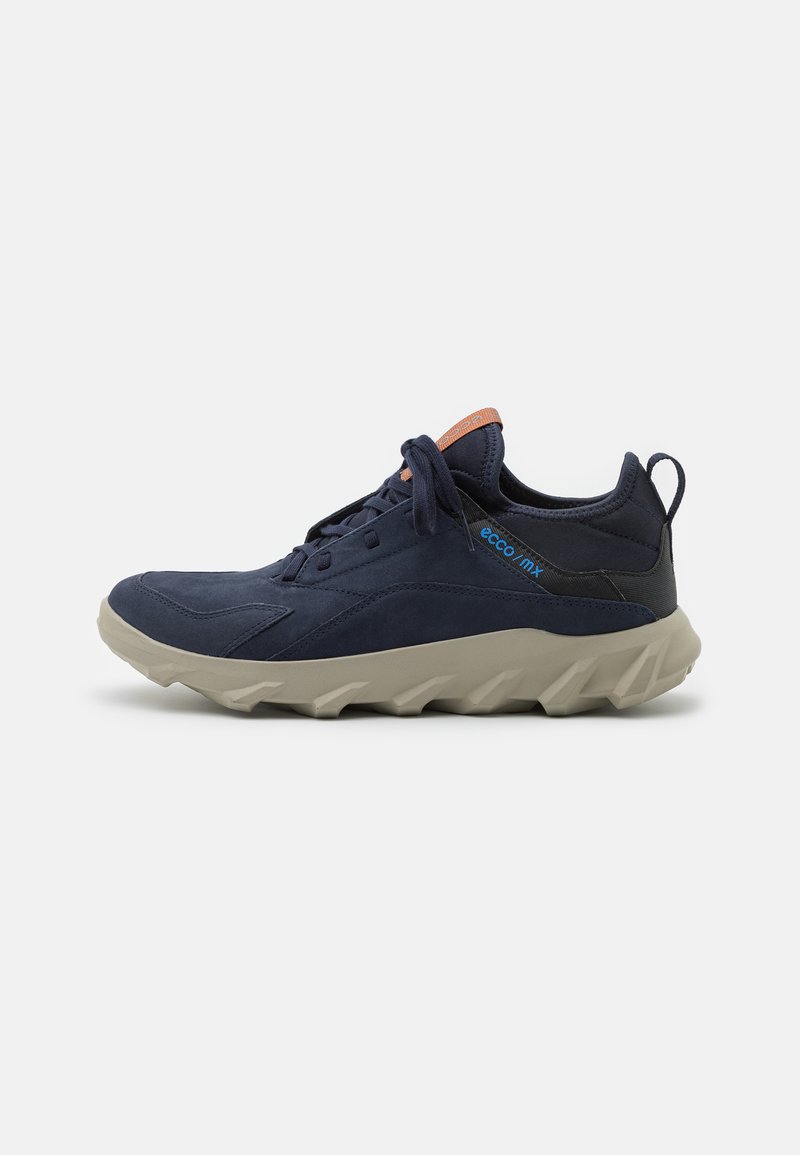 Navy blue sneaker with a suede upper, textured toe, and beige rubber sole with a jagged design. Features a contrasting orange accent on the tongue.
