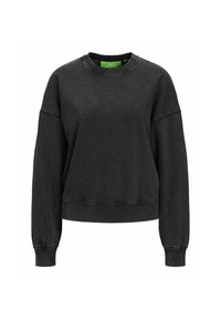 Sudadera negra corta con mangas largas, puños y bajo acanalados, hecha de una tela suave, que presenta una etiqueta de marca verde en el interior del cuello.