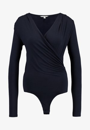 Tengerészeti, hosszú ujjú bodysuit, átlós szabással, sima, rugalmas anyagból és mély V-kivágással. Alul záródik a biztonságos illeszkedés érdekében.