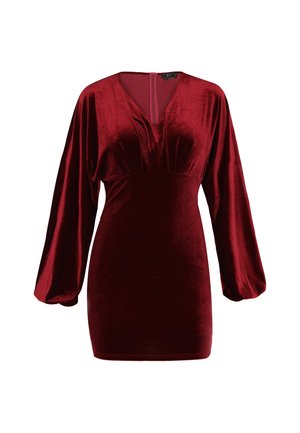 Rode fluwelen jurk met een diepe V-hals, lange ballonmouwen en een fitted silhoët. Bevat plissé-details bij het lijfje en een ritssluiting aan de achterkant.