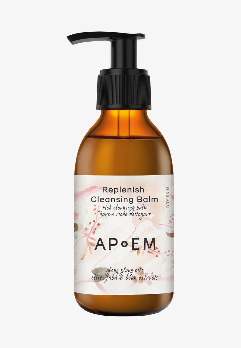 Bouteille en verre ambré avec un bouchon-pompe noir. L'étiquette présente des motifs floraux en rose et beige, le texte identifie le produit comme "Baume Nettoyant Réapprovisionnant".