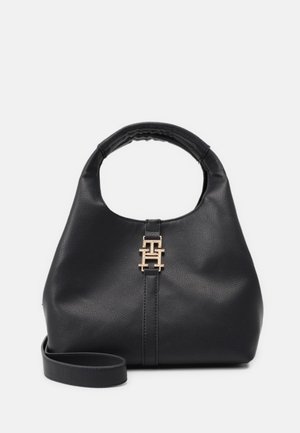 Black leather handbag with rounded handle, gold interlocking "T" logo clasp on front, and detachable shoulder strap on white background.