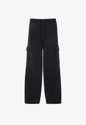Black cargo pants with an elastic waistband, adjustable drawstring, two side pockets, and a relaxed fit. Crafted from textured fabric.