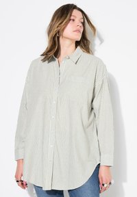 Striped long-sleeve shirt in light green and white, featuring a button-up front, collared neckline, and pocket on the left side.