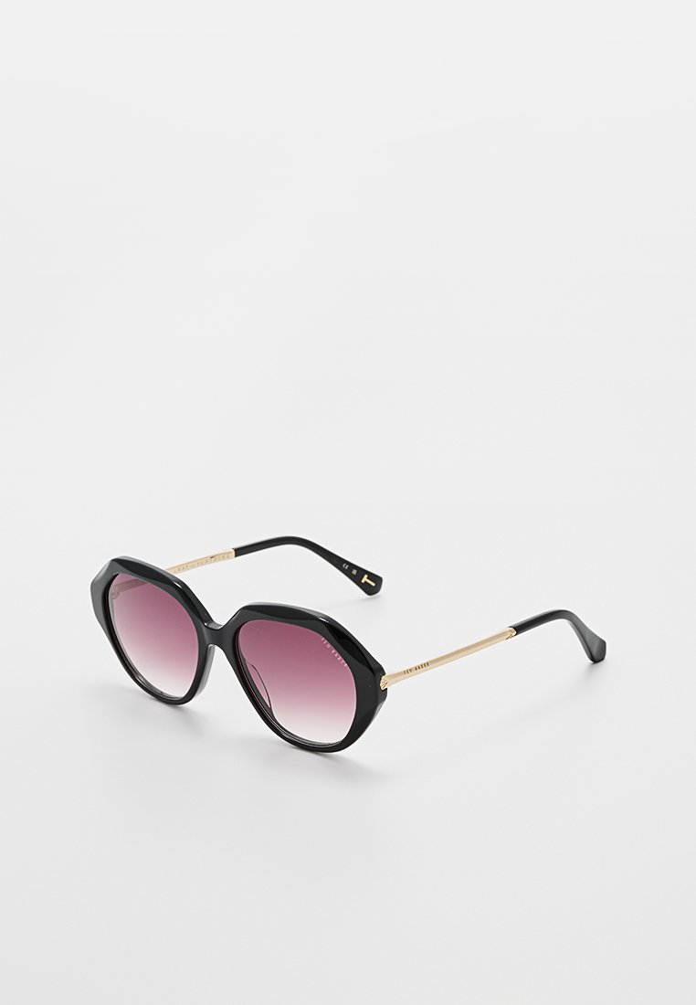 Black sunglasses with an octagonal frame, featuring gradient purple lenses and gold-colored metal arms with detailed accents.