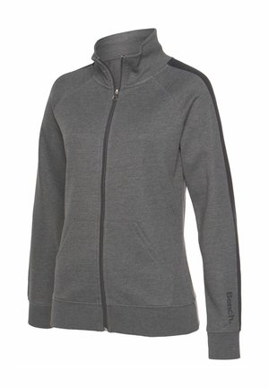 Šedá zipová mikina z měkkého materiálu, s vyšším límcem, bočními pruhy a předními kapsami. Logo na rukávu.