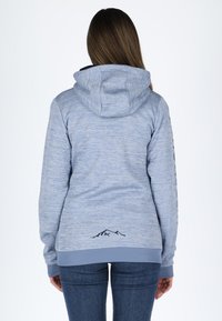 Light blue hoodie with a textured finish, featuring a black mountain graphic at the back hem and ribbed cuffs and waistband.