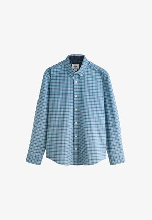 Mėlynas ir baltas langeliais ilgomis rankovėmis marškiniai su mygtukų apykakle, ant krūtinės siuvinėtu logotipu ir tiesia apatine dalimi.