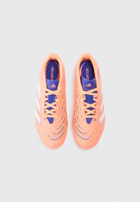 Pair of orange Adidas Predator football cleats with white stripes and blue detailing, viewed from above on a neutral background.