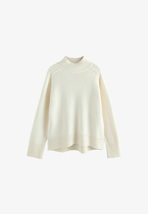 Sweter w kolorze kremowym z żebrowanym kołnierzem typu mock, długimi rękawami i luźnym krojem. Teksturowana dzianina i żebrowany detal na dole.