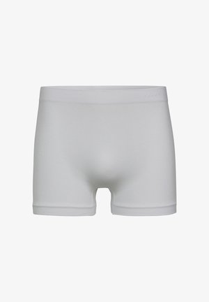 Boxer bianchi senza cuciture con una fascia larga in vita e gambe corte, esposti su uno sfondo bianco semplice.