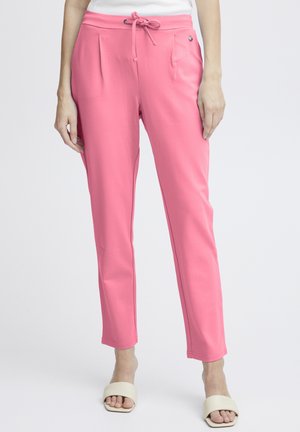 Pink relaxed-fit pants with front pleats, drawstring waistband, and pockets. Soft fabric with a smooth texture and tapered leg design.