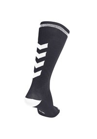 Calza compressiva nera con un motivo a zigzag bianco, bordo rigato, tallone rinforzato e punte rinforzate, realizzata con un tessuto testurizzato.