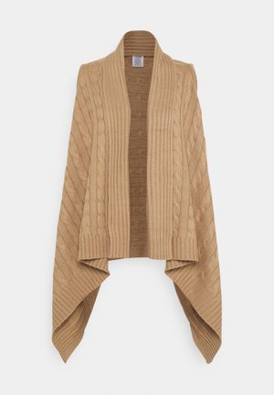 Stickad sjal i ljusbrun, med ribbade kanter och flätstickade mönster. Öppen framsida med draperade ärmar och texturell kontrast.