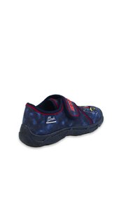 Blauer Stoffschuh mit einem Klettverschluss, versehen mit einem gelben grafischen Design an der Seite. Strukturierte schwarze Gummisohle in runder Form.
