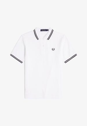 Witte polo met korte mouwen, met zwarte dubbele strepen op de kraag en manchetten, een knoopsluiting en een klein zwart geborduurd logo op de borst.