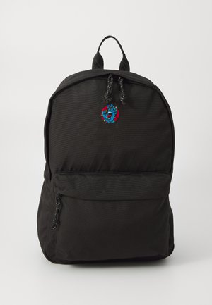 Zwarte rugzak met een gladde, gestructureerde afwerking, voorzien van een voorvak met rits en een geborduurd blauw en rood embleem aan de voorkant.