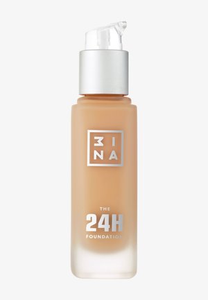 Liquid foundation in a frosted glass bottle, light beige color, with a silver pump top and clear cap. Text on label in silver and black.
