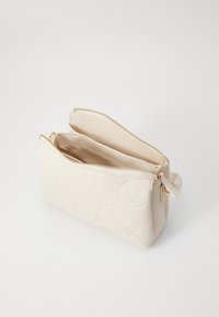 Cream-colored zippered bag featuring an embossed logo pattern, zipper pulls, and a smooth textured surface. Two compartments visible.