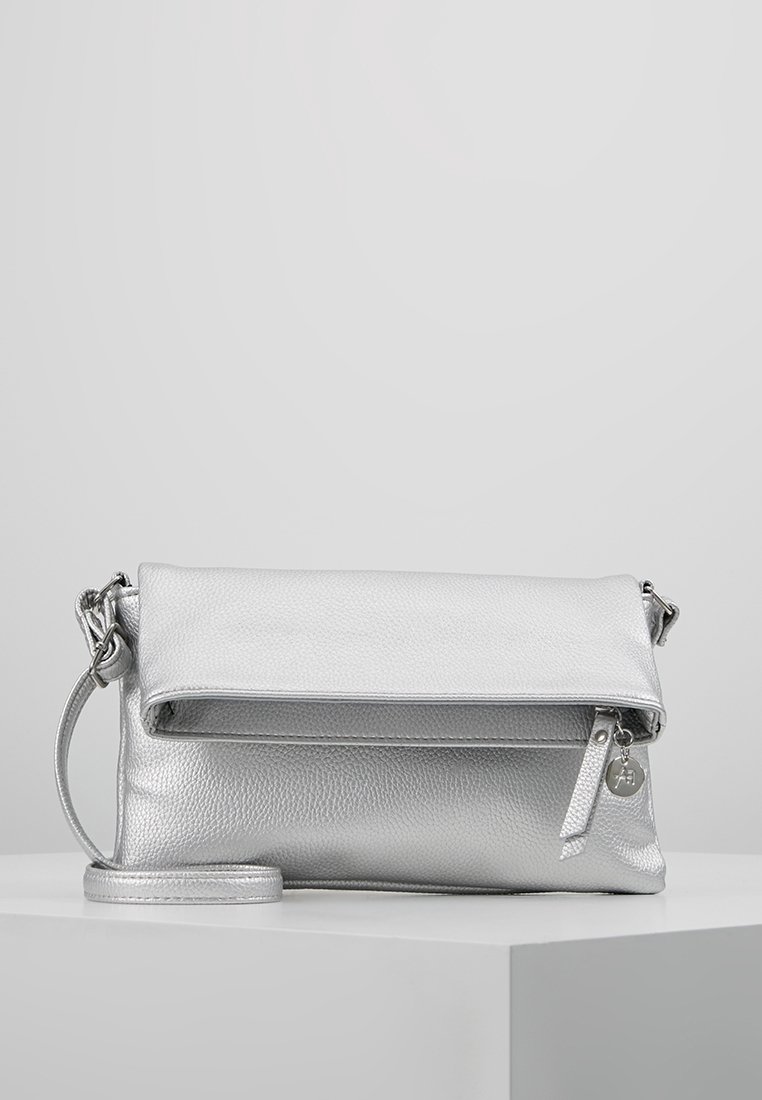 Silver leather handbag with a textured finish, fold-over flap, zipper closure, and detachable strap. Features a small logo charm.