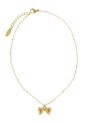 Złoty naszyjnik łańcuchowy z małymi okrągłymi koralikami i centralnym wisiorkiem w kształcie kokardki, wyposażony w regulowane zapięcie i przedłużki.