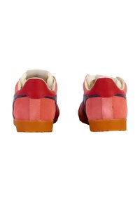 Suede sneakers in pink and red, featuring a textured upper, white lining, and orange rubber soles. Simple design with contrasting colors.