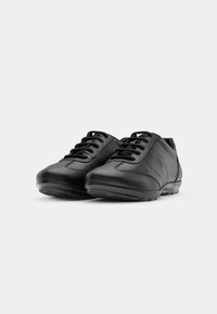 Pantofi din piele neagră cu vârf rotund, design cu șireturi și oiseală subtilă. Textură netedă cu o talpă din cauciuc pentru aderență.