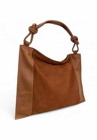 Sac en cuir et daim marron avec une poignée nouée, présentant un design décontracté et une combinaison de matériaux texturés.