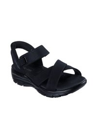 Schwarze Sandalen mit verstellbaren Klettverschlüssen, gepolstertem Fußbett, strukturierten Gummisohlen und offenem Zehenbereich. Entworfen für Komfort und Unterstützung.